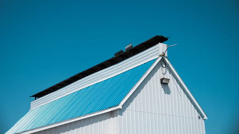 Gulf Coast building with a blue and white metal roof under a clear sky