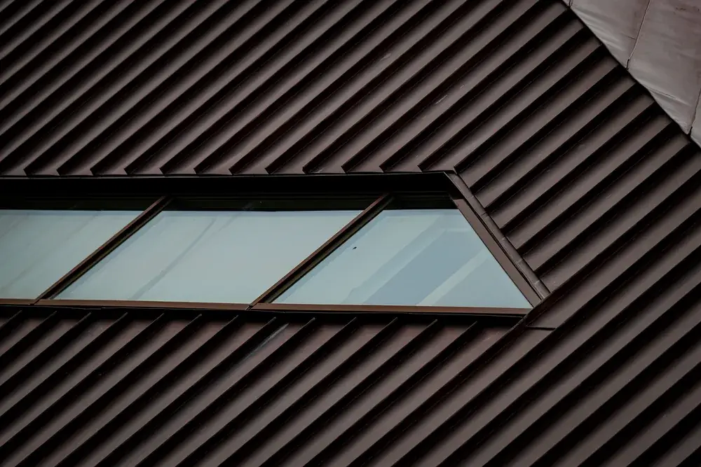 Close-up of a metal roof panel and skylight edge detail